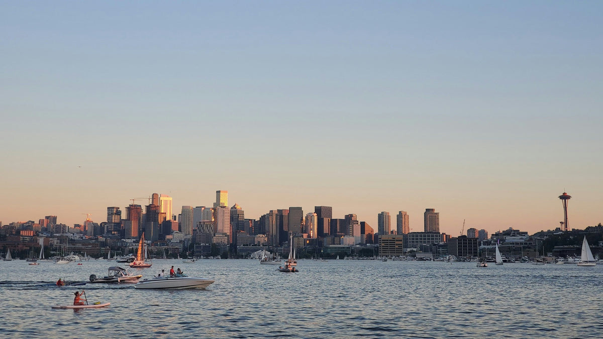 Downtown Seattle and the Space Needle at sunset across Lake Union, with boats on the water